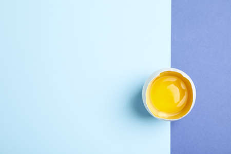 Egg yolk on two tone background, space for textの写真素材