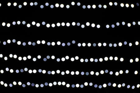 Blurred lights on black background, space for text