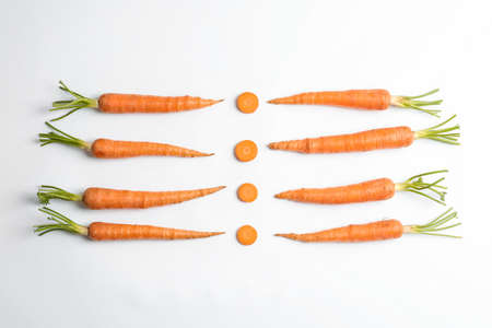 Flat lay composition with ripe fresh carrots on white backgroundの写真素材
