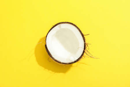 Half tropical coconut on color background, space for textの写真素材