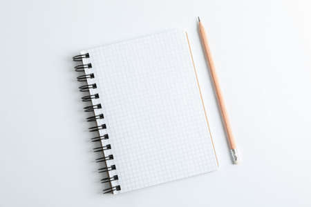 Clean copybook with pencil on white background, space for textの写真素材