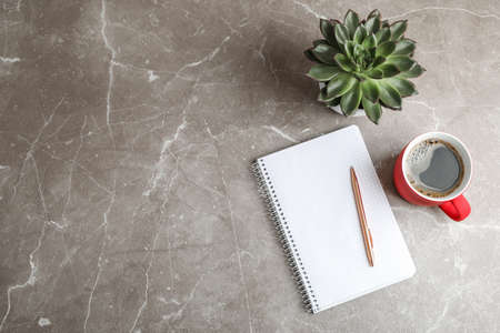 Flat lay composition with cup of coffee, copybook and succulent plant, space for textの写真素材