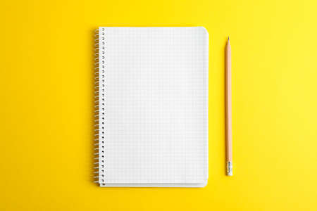 Clean copybook with pencil on color background, space for text