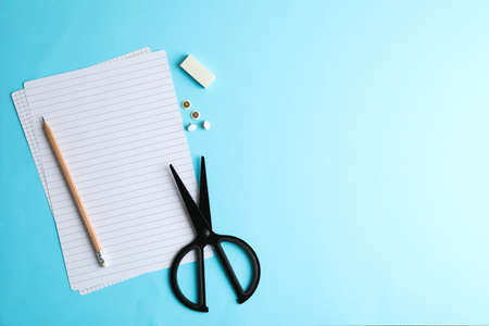 Scissors, pencil and sheets on color background, space for textの写真素材