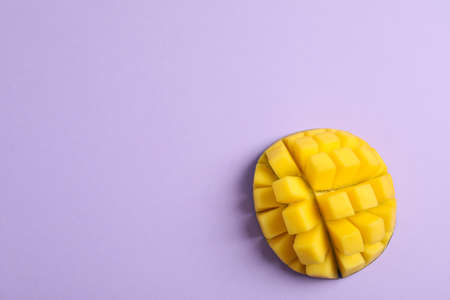 Cut tropical ripe mango and space for text on color background, top viewの写真素材