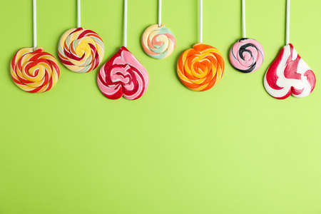 Flat lay composition with different candies and space for text on color background