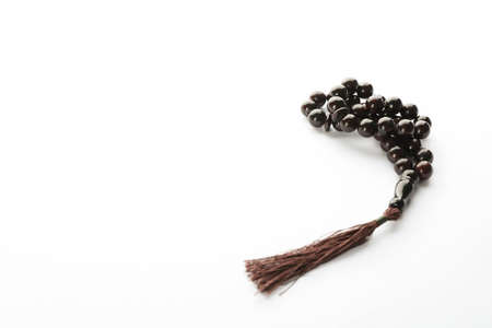 Prayer beads on white background, space for text