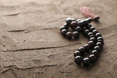 Prayer beads on brown background, space for textの写真素材