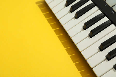 Midi keyboard on color background, space for textの写真素材