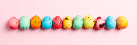 Decorative Easter eggs on color background, space for text. Top view