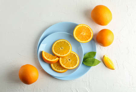 Plates with orange slices on white background. Top view, space for textの写真素材