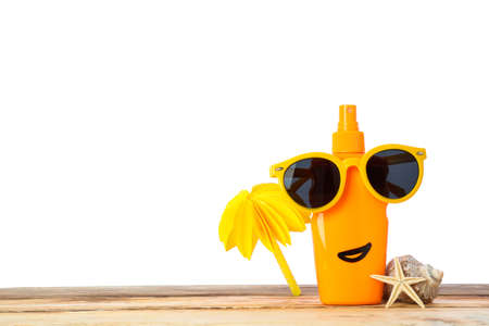 Sunscreen spray with sunglasses, starfish, seashell and decorative palm on wooden table, isolated on white background. Safe tanの写真素材