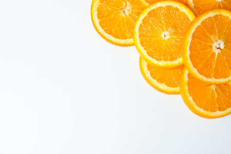 Composition with orange pieces on white background, space for text and closeup. Citrus fruits