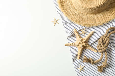 Tablecloth with straw hat, starfishes and sea rope on white background, space for text and top view. Summer vacationの写真素材