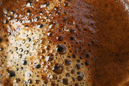 Coffee with frothy foam as background, space for text and closeup. Break timeの写真素材