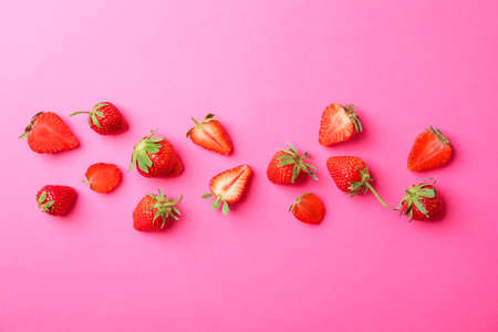 Flat lay composition with strawberries on color background, space for text. Summer sweet fruits and berriesの写真素材