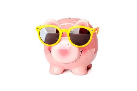 Happy piggy bank with sunglasses isolated on white background. Finance, saving moneyの写真素材