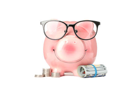 Happy piggy bank with glasses and money isolated on white background. Finance, saving moneyの写真素材