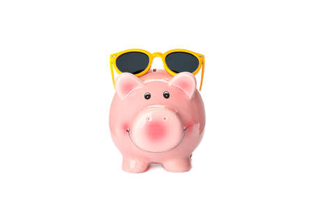 Happy piggy bank with sunglasses isolated on white background. Finance, saving moneyの写真素材