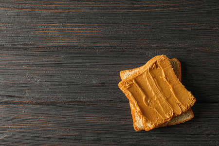 Peanut butter sandwich on wooden background, space for text and top viewの写真素材