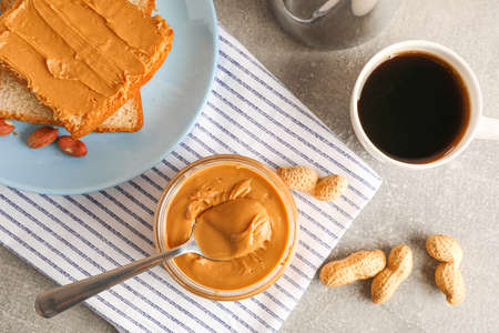 Yummy peanut butter breakfast on grey background, top viewの写真素材