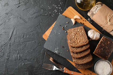 Composition with bread on cutting board, space for text and top view