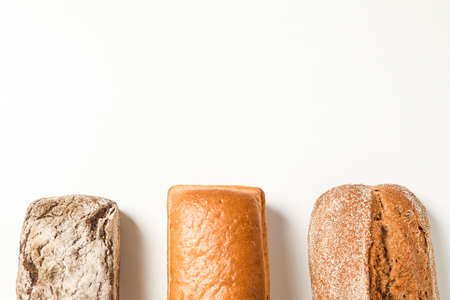 Flat lay composition with bakery products on white background, space for text