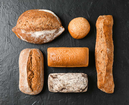 Flat lay composition with bakery products on black background, top view