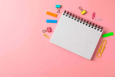 Notebook, clips and stickers on color background, space for textの写真素材