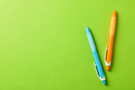Pens on green background, space for text