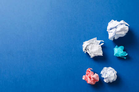 Flat lay composition with crumpled paper balls on color background, space for textの写真素材