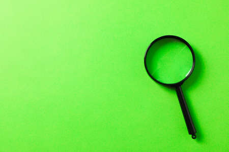 Magnifier on green background, space for textの写真素材