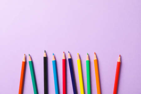 Flat lay composition with multicolor pencils on violet background, space for textの写真素材