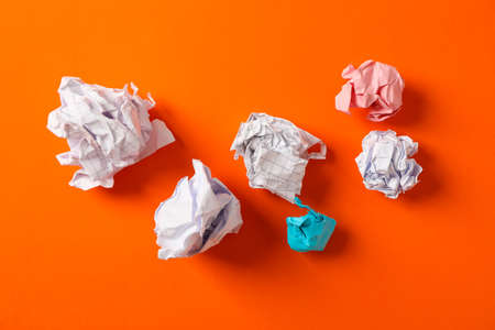 Flat lay composition with crumpled paper balls on color background, space for textの写真素材