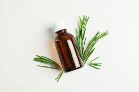 Flat lay composition with rosemary oil and leaves on white background, space for textの写真素材