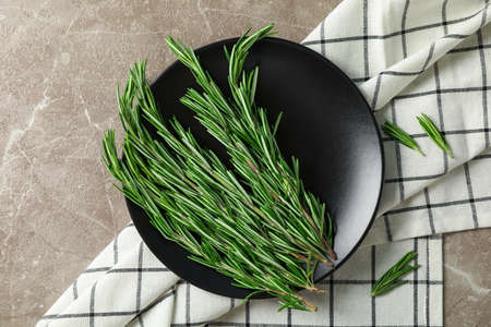 Plate with rosemary and towel on grey table, top viewの写真素材