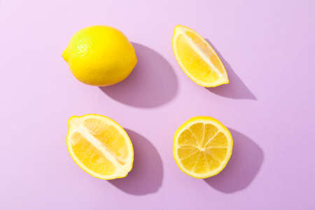 Flat lay composition with lemons on color background, space for textの写真素材