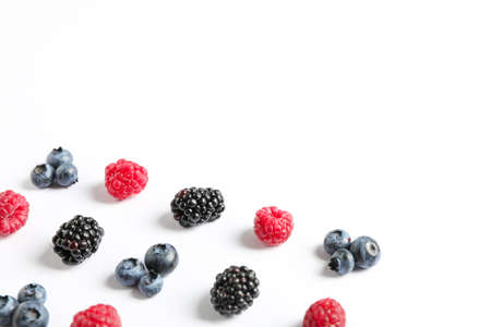 Flat lay composition with berries on white background, space for text