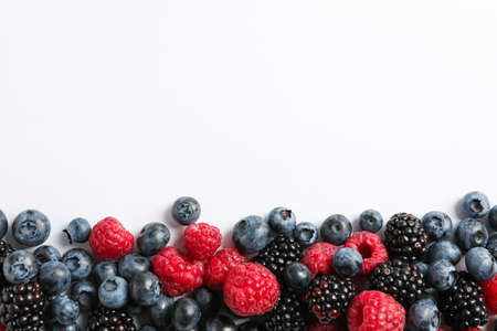 Flat lay composition with berries on white background, space for textの写真素材