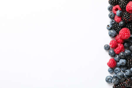 Flat lay composition with berries on white background, space for text
