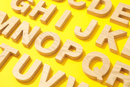 Wooden letters of English alphabet on color backgroundの写真素材