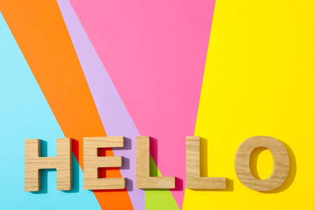 Word Hello lined with wooden letters on multicolor backgroundの写真素材