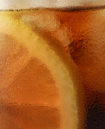 Side view background of cold cola with ice in glass, closeupの写真素材
