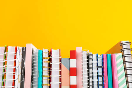 Stack of colorful books against background, space for textの写真素材