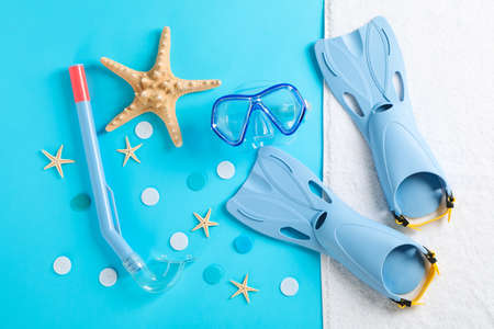 Sea vacation accessories on yellow background, top view