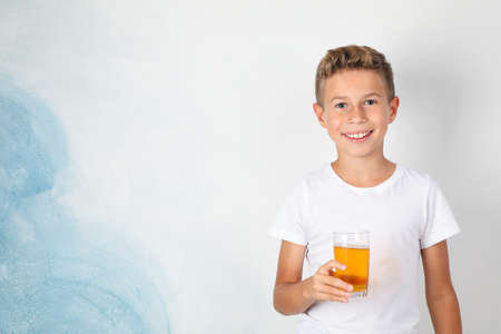 Smile boy with sweet cocktail against white backgroundの写真素材