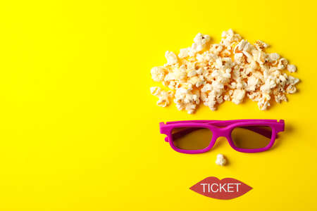 Flat lay composition with movie watching accessories on yellow background, top viewの写真素材