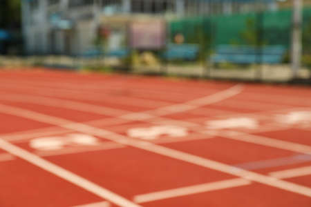 Start of red athletic track with numbers, blurred backgroundの写真素材