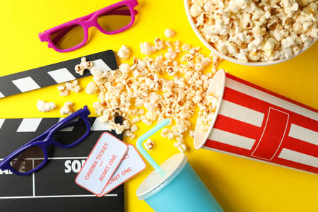 Flat lay composition with movie watching accessories on yellow backgroundの写真素材