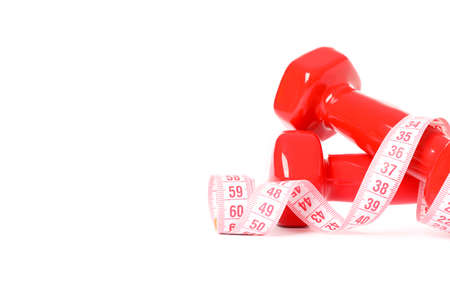 Dumbbells and measuring tape isolated on white backgroundの写真素材